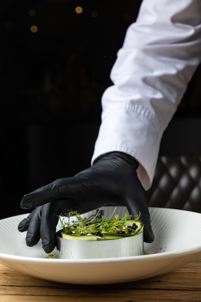 chef-is-putting-knife-into-dish-food