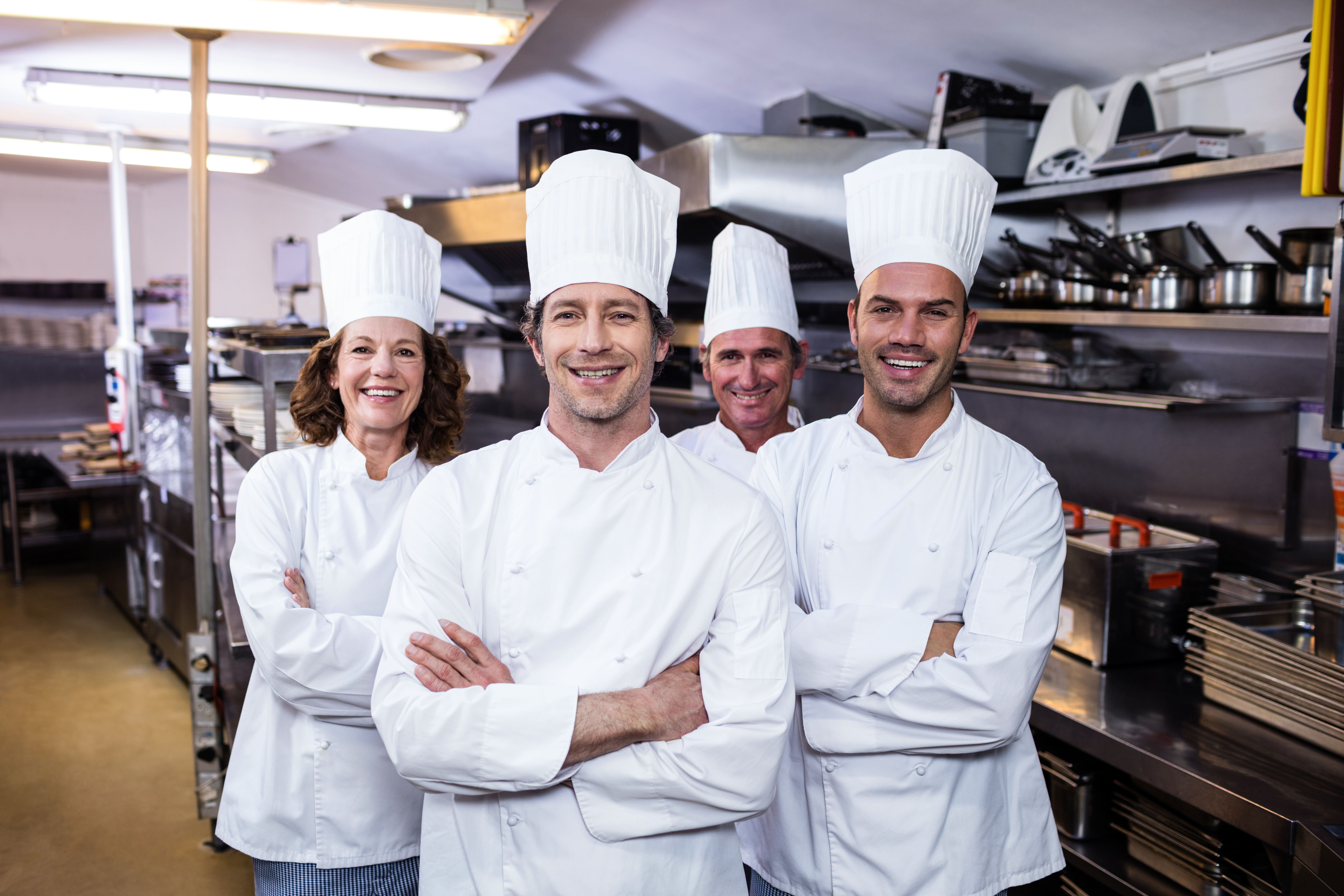 group-happy-chefs-smiling-camera