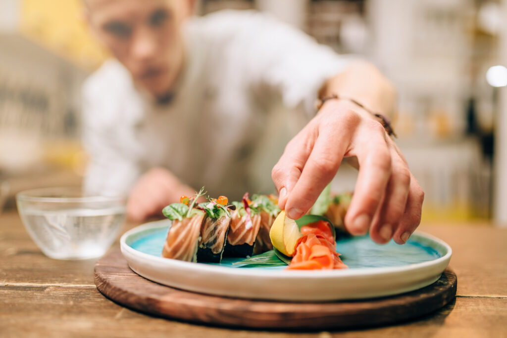 male-chef-cooking-sushi-rolls-japanese-food-preparation-process
